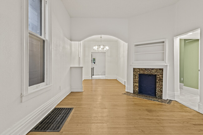 Living room has decorative fireplace and is completely open to dining room/kitchen. - 2925 Holmes St