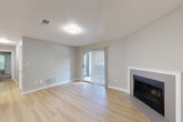 Located at 4659 Dawson Blvd in Atlanta, GA, this single-story, 2-bedroom, 2-bathroom home offers a well-designed layout across a comfortable footprint. The living room serves as the heart of the home, featuring light-toned hardwood-style flooring, a textured ceiling, neutral gray walls, and a sleek fireplace framed by a clean white surround. A sliding glass door with vertical blinds fills the space with natural light and provides outdoor access. The adjacent dining area flows naturally from the living space, creating an open and connected feel. The kitchen is outfitted with gray cabinetry, white countertops, a subway tile backsplash, stainless steel appliances, and a double-basin sink, complemented by a pantry for additional storage. The spacious primary bedroom includes carpet flooring, a ceiling fan, and a bright window overlooking the outdoors, while a generous walk-in closet with wire shelving offers excellent organization. The second bedroom and additional closets provide further flexibility. Both bathrooms feature tile-surround tub/shower combinations and hardwood-style flooring. The home also includes a hallway, utility room, and dedicated laundry area, rounding out a practical and functional floor plan throughout.
