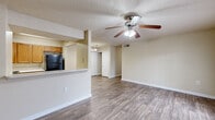 Located at 3629 Montreal Creek Cir in Clarkston, Georgia, this single-floor residence offers a practical and well-maintained layout designed for comfortable everyday living. The open living area is finished with durable wood-look flooring and features a ceiling fan with integrated lighting. A pass-through counter connects the living space to the kitchen, where warm wood cabinetry, white countertops, a double stainless steel sink, and black appliances — including a refrigerator, range, and dishwasher — provide a fully functional cooking environment. French doors in the living area allow natural light to flow in and provide access to the exterior. The bedrooms are carpeted for comfort and include closet space, with one room featuring a walk-in closet. Bathrooms are equipped with accessibility-friendly features, including grab bars near the toilet and in the tub/shower combination, and are finished with wood-look flooring. A wall-mounted vanity mirror and overhead lighting complete the bathrooms. Throughout the unit, textured ceilings, neutral wall tones, and consistent flooring choices contribute to a cohesive and understated aesthetic. The space is well-suited for those seeking a functional, move-in-ready home in the Clarkston area.