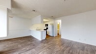 Located at 340 W Duarte Rd in Monrovia, CA, this well-organized 2-bedroom, 2-bathroom single-floor residence offers a practical and comfortable layout. The open-concept living and dining area is a standout feature, showcasing durable hardwood-style flooring, a ceiling fan, and a sliding glass door that opens to a private balcony with outdoor views — filling the space with natural light. A peninsula counter connects the living area to the galley-style kitchen, which is equipped with white cabinetry, a gas range, refrigerator, and a sink with ample counter space, all complemented by light wood-tone flooring. Both bedrooms feature plush carpeting and vertical blinds that allow for adjustable natural light. The generously sized primary bedroom includes a walk-in closet and direct hallway access. The second bedroom is equally comfortable with its own closet and window. Both bathrooms are clean and functional, each featuring a full tub-shower combo with chrome fixtures and white surrounds. Textured ceilings are present throughout the home, adding a consistent finish. A dedicated hallway connects the main living spaces to the bedrooms and bathrooms, ensuring a logical and private flow throughout the residence.
