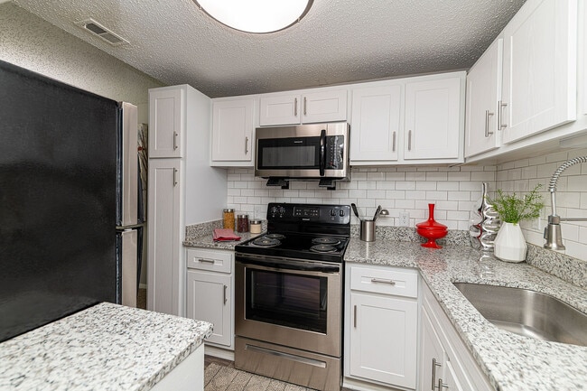 Kitchen with granite counters and stainless appliances - Hudson on the Greenway