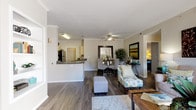 Located at 8000 W Crestline Ave in Denver, Colorado, this single-floor residence offers a thoughtfully designed open-concept layout. The living area is finished with rich wood-style flooring, crown molding, and a ceiling fan, and flows seamlessly into a dedicated dining space. Large sliding glass doors invite abundant natural light and provide access to an outdoor patio with neighborhood views. The kitchen is equipped with stainless steel appliances — including a refrigerator, range, and microwave — complemented by light wood cabinetry, dark granite-style countertops, and a double basin sink. A dedicated laundry area with a washer and dryer is conveniently accessible off the kitchen. Both bedrooms feature plush carpeting and generous windows that brighten each room. The two bathrooms are finished with wood-style flooring, white cabinetry, granite-style countertops, and full tub-shower combinations with tile surrounds. Neutral wall tones throughout create a cohesive and versatile aesthetic, making this residence a comfortable and functional home in the Denver metro area.