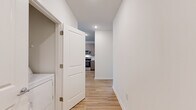Located at 1296 Moreland Ave SE in Atlanta, GA, this well-appointed 2-bedroom, 2-bathroom home offers a thoughtfully designed single-floor layout with a clean, contemporary aesthetic. Light hardwood-style flooring runs throughout every room, creating a cohesive and modern feel.

The kitchen serves as a central highlight, featuring a large granite-topped island, two-tone cabinetry with taupe upper cabinets and wood-grain lower cabinets, a subway tile backsplash, and a full suite of stainless steel appliances including a refrigerator, range, over-the-range microwave, and dishwasher. Recessed lighting adds brightness to this open-concept space, which flows naturally into the living area.

Both bedrooms are bright and well-proportioned, each equipped with ceiling fans and large windows fitted with blinds that invite ample natural light while offering views of the surrounding neighborhood. The primary bedroom is generously sized and includes a walk-in closet outfitted with wire shelving for organized storage.

The bathrooms are finished with granite-topped wood-grain vanities and full tub-shower combinations with clean white tile surrounds. A dedicated laundry area with in-unit washer and dryer hookups adds everyday convenience. The home's crisp white walls and consistent finishes throughout create a bright, move-in-ready atmosphere.