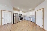 Located at 15037 Tahoma Blvd SE in Yelm, Washington, this single-story, three-bedroom, two-bathroom home offers a thoughtfully organized layout with modern finishes throughout. Warm-toned, wood-look luxury vinyl plank flooring and crisp white walls flow consistently through every room, creating a clean, cohesive aesthetic.

The kitchen is a functional highlight, featuring white upper cabinetry, gray lower cabinets, granite-look countertops, and a full suite of stainless steel appliances including a refrigerator, gas range, microwave, and dishwasher. Recessed lighting illuminates the space effectively. The kitchen connects conveniently to the open living area, which provides a comfortable, flexible layout.

A central hallway connects the three bedrooms, each finished with the same durable flooring and warm wood trim. The spacious primary bedroom offers generous room and its own closet. Additional bedrooms are served by a second closet. The bathrooms are clean and practical, with one featuring a sliding-glass enclosed shower stall and granite-accented vanity.

A dedicated laundry room houses a full-size top-load washer and dryer. A wall-mounted ductless mini-split unit provides efficient heating and cooling. Throughout the home, warm wood door and window trim accents add a welcoming touch to the bright, move-in-ready interior.