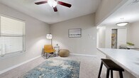 This single-story residence offers a thoughtfully designed layout across two bedrooms and two bathrooms. The living room features plush wall-to-wall carpeting, a ceiling fan, and an open sightline into the kitchen, creating a cohesive and functional common area. The kitchen is appointed with white shaker-style cabinetry, marble-look countertops, light wood-style vinyl flooring, stainless steel appliances including a dishwasher, microwave, and range, as well as a double sink — all arranged in an efficient galley-style configuration.

The bedrooms are carpeted and finished in the same neutral warm-gray palette that carries throughout the unit. Each room features a ceiling fan, natural light from blinds-fitted windows, and easy access to a bathroom. The primary bedroom is a comfortably sized retreat with an adjoining bathroom area. Both bathrooms include a tub-shower combination, white vanity cabinetry, marble-look countertops, large mirrors with vanity lighting, and wood-look tile flooring. A dedicated closet provides additional storage. The overall aesthetic is clean, neutral, and move-in ready.