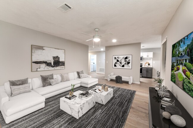 Large living area with wood-like floors - Avana Chase