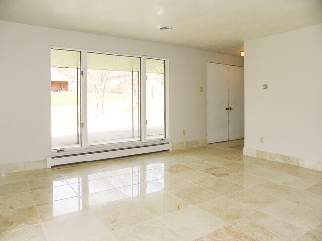 Inside, beautiful tile leads through the main living spaces. - 6445 Union Ave