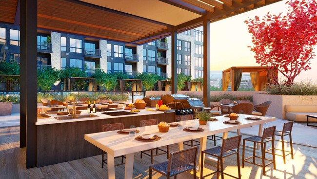 Outdoor covered patio featuring grilling stations at One Rangers Luxury Apartments - One Rangers Way