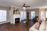 Located in Knoxville, Tennessee, this two-story home at 9400 Havenbrooke Way offers a well-designed layout with thoughtful finishes throughout. The main level features rich hardwood flooring that flows through the living and dining areas, complemented by crown molding and ceiling fans. The living room is anchored by a classic white-mantled fireplace and receives generous natural light through a set of French doors and surrounding windows. A dedicated dining area features a corner window arrangement with a decorative chandelier overhead, creating a bright and inviting space for meals. The kitchen is appointed with warm honey-toned cabinetry, dark granite-style countertops, a double sink, and track lighting, providing both functionality and style. A compact powder bath on the main level offers chrome fixtures and a decorative framed mirror. A staircase with a wood banister leads to the upper level, where multiple bedrooms are found, each with ceiling fans and carpeted flooring. The primary bedroom is spacious and well-lit, while additional bedrooms offer versatile use as guest rooms or a home office. An upper-level full bathroom mirrors the kitchen's aesthetic with matching cabinetry and dark countertops. Throughout, neutral wall tones and consistent finishes create a cohesive and comfortable atmosphere.