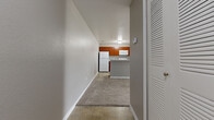 Located at 1202 Prairie Ln in Titusville, Florida, this single-story, 3-bedroom, 2-bathroom home offers a practical and comfortable layout. An entry hallway with tile flooring and a louvered closet door welcomes you inside, leading to the open-concept living and kitchen area. The kitchen features warm cherry-toned cabinetry, a white appliance suite including a refrigerator, range, and built-in microwave, and a breakfast bar peninsula that separates it from the carpeted living space. The living area is generously sized, filled with natural light from a large window, and equipped with a ceiling fan. Each of the three bedrooms is carpeted and includes windows that bring in natural light and outdoor views of surrounding greenery. The primary bedroom is a comfortable size and includes dedicated closet space. The two bathrooms are finished with tile flooring and feature full tub-shower combinations with white tile surrounds, offering clean and functional designs. Two closets provide additional storage throughout the home. Neutral gray walls and consistent finishes create a cohesive, move-in ready atmosphere throughout this well-laid-out Titusville residence.