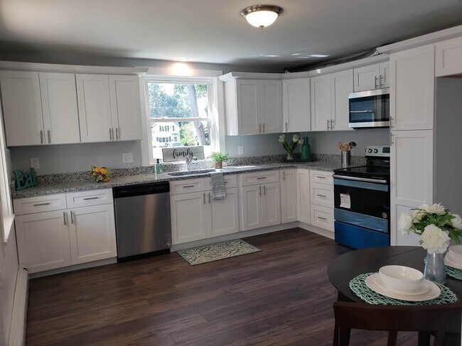 Spacious kitchen with stainless appliances and granite countertops - 24 Forest St