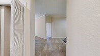 This well-designed apartment at Andover Place at Cross Creek offers 1110 square feet of living space on a single floor. The unit boasts three bedrooms, including a primary bedroom of 160 square feet, and four bathrooms, providing ample space and privacy for residents and guests. The modern kitchen features stainless steel appliances, granite countertops, and rich wood-look flooring that extends into the living areas. The open-concept living and dining area is complemented by plush carpeting and a ceiling fan for comfort. Large windows allow natural light to flood the space, while a balcony offers outdoor living options. Built-in features include an arched wall niche and shelving in the living area, adding character and functionality. The bathrooms are outfitted with modern fixtures, including a combination shower/tub. Ample storage is provided through walk-in closets with wire shelving systems. The neutral color palette throughout the apartment allows for easy personalization, making this space a versatile and comfortable home in a desirable community setting.
