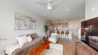 Located in North Venice, FL, this thoughtfully designed two-story home offers 3 bedrooms, 3 bathrooms, and generous living space spread across two floors. The main level features an open-concept layout where the living room, dining area, and kitchen flow seamlessly together. The modern kitchen is outfitted with warm wood-toned cabinetry, stainless steel appliances, a white quartz waterfall island with bar seating, and sleek pendant lighting. The living area is bright and airy, with a ceiling fan, recessed lighting, and large windows that invite natural light and views of the lush Florida landscape. The dining nook, illuminated by a statement pendant light, overlooks greenery through wide windows. Rich wood-look flooring runs throughout the main level, complementing the home's contemporary aesthetic. A dedicated laundry room with a full-size washer and dryer adds everyday convenience, while the attached garage provides ample storage and parking. Upstairs, three well-proportioned bedrooms feature plush carpeting and ceiling fans, with the primary suite offering a comfortable, private retreat. Six closets throughout the home ensure abundant storage. Clean white walls and modern finishes create a cohesive, move-in-ready feel throughout.