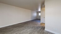 Located at 3434 E McDowell Rd in Phoenix, AZ, this one-bedroom, one-bathroom unit offers a well-designed, single-level layout that makes efficient use of its compact footprint. The open-concept living and kitchen area forms the heart of the unit, with neutral-toned walls and consistent wood-look luxury vinyl plank flooring throughout, creating a cohesive and clean aesthetic. The living room receives natural light through a window fitted with blinds, contributing to a bright and airy feel.

The kitchen is a functional standout, featuring white cabinetry with modern hardware, dark countertops, and stainless steel appliances including a freestanding electric range and a full-size refrigerator. A skylight overhead floods the kitchen with additional natural light, adding an open, welcoming character to the space.

The bedroom is a well-proportioned, private retreat with its own window for natural light and ventilation, smooth walls, and the same wood-look flooring that runs throughout the unit. A dedicated doorway provides a clear separation from the main living area.

The bathroom is clean and functional, equipped with a full-size soaking tub and shower combo featuring white surround walls and chrome fixtures. The unit's overall design emphasizes simplicity, cleanliness, and practicality, making it a comfortable and move-in ready space in Phoenix.