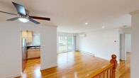 Located at 7940 Janes Ave in Woodridge, IL, this well-appointed single-floor home offers three bedrooms and one bathroom across a thoughtfully designed layout. Warm hardwood floors run throughout the entire residence, lending a cohesive and inviting feel to every room. The open living area is bright and airy, bathed in natural light from large sliding glass doors that lead out to a private balcony with pleasant outdoor views. Recessed lighting and a ceiling fan add both functionality and style to the living space, which is also equipped with a wall-mounted mini-split system for efficient climate control. The kitchen features light wood cabinetry paired with dark granite countertops, a double-basin sink, and a natural light-filled window — offering an efficient and attractive workspace. Each of the three bedrooms is comfortable and well-proportioned, with the spacious primary bedroom boasting sliding balcony access, a ceiling fan, and a built-in closet. Additional bedrooms include closet storage and wall-mounted climate units. The bathroom is elegantly finished with marble-style tile flooring and a tiled tub-shower surround accented by a decorative mosaic border, and conveniently houses a stacked in-unit washer and dryer.