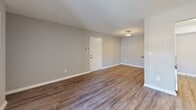 Located at 905 Bryan Pl in Garner, NC, this one-bedroom, one-bathroom unit offers a well-organized single-floor layout designed for comfortable everyday living. Wood-style plank flooring runs throughout, complementing neutral gray walls and white trim for a clean, modern aesthetic. Textured ceilings add architectural character across the space.

The open living and dining area is a standout feature, boasting built-in wall shelving for display or storage and a sliding glass door that fills the room with natural light while providing direct access to a private balcony with outdoor views. A second set of built-in shelves adds additional functional charm near the entryway.

The galley-style kitchen is efficiently designed with white cabinetry, subway tile backsplash, dark countertops, a double-basin sink, dishwasher, electric range, and a refrigerator. A dedicated pantry provides additional storage, and the kitchen opens conveniently toward the in-unit laundry area.

The bedroom is a comfortable retreat featuring a window with natural light, hardwood-style flooring, and access to ample closet space. The full bathroom includes a wide vanity with under-sink cabinetry, a large mirror, gray countertop, and a tub/shower combination. A hallway connects all areas seamlessly, rounding out this practical and move-in-ready home.