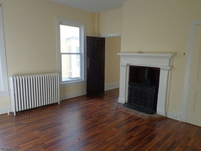 Living room door to bedroom dormant fireplace - 47 W Main St