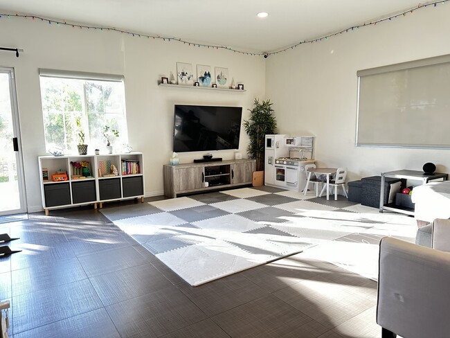 Living room with upgraded tiles (playmats will be removed) - 1583 W Katella Ave