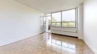 Located at 4750 Bathurst Street in North York, Toronto, this one-bedroom, one-bathroom unit offers a well-organized and functional layout across a single floor. The entrance hallway leads into the main living area, where polished parquet flooring extends throughout the space, reflecting natural light and adding warmth to the clean, white-painted walls. The living room is a bright, open area featuring floor-to-ceiling windows and a glass balcony door that opens to an outdoor balcony overlooking lush greenery — a standout feature that brings a sense of nature into the home. Baseboard heating runs along the window walls, ensuring year-round comfort. The kitchen has been thoughtfully updated with white shaker-style cabinetry, dark countertops, a stainless steel undermount sink, a subway tile backsplash, and a dishwasher, offering both style and practicality. The bedroom is a comfortable, well-sized room with parquet flooring, a built-in closet, and access to the hallway. The bathroom features a full soaker tub and shower surrounded by glossy white subway tiles with chrome fixtures, delivering a clean, modern aesthetic. The overall ambiance of the unit is bright, neutral, and move-in ready.