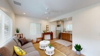 This 420 square foot apartment in Los Angeles offers a thoughtful blend of comfort and functionality within a compact footprint. The single-story layout comprises one bedroom, one bathroom, a living room, kitchen, and closet space. The living area is bright and inviting, with recessed lighting and a ceiling fan complementing the natural light from large windows. A grey sofa anchors the space, accented by a jute rug and decorative pillows, creating a cozy atmosphere.

The 110 square foot bedroom comfortably accommodates a queen-sized bed and features a large window for natural light. The kitchen, while compact, is well-equipped with stainless steel appliances, including a gas range, microwave, and a convenient washer-dryer stack. Light wood flooring throughout adds warmth and continuity to the space.

The bathroom showcases a modern design with a blue vanity, white countertop, and ample storage. Large windows in every room ensure the apartment feels spacious and airy despite its modest size. The efficient floor plan maximizes every square foot, making this apartment an ideal option for those seeking a stylish, low-maintenance living space in the heart of Los Angeles.