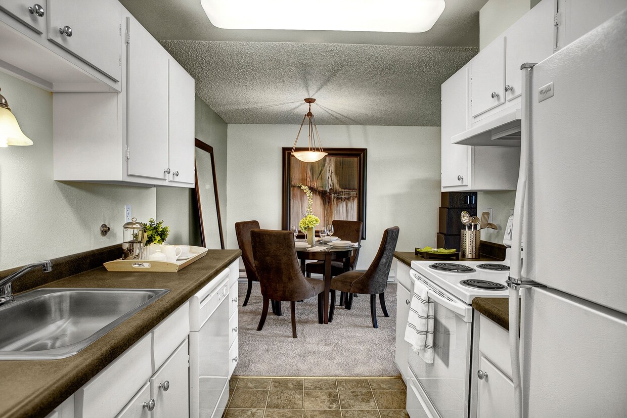 A kitchen with plenty of counter space, dishwasher, and lots of cabinet storage - Arrive Magnolia