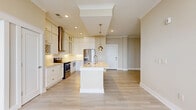 Located at 7511 Solstice Cir in Orlando, FL, this well-appointed 3-bedroom, 3-bathroom single-floor home offers a thoughtfully designed open-concept layout with a warm, neutral color palette throughout. Light wood-look flooring flows seamlessly through the main living areas, complementing the natural light that pours in through large windows.

The kitchen is a standout centerpiece, featuring white shaker cabinetry, stainless steel appliances, a stainless range hood, a herringbone tile backsplash, and a generous island with pendant lighting — ideal for both cooking and casual dining. The open flow connects the kitchen directly to the dining and living areas, creating an inviting, social atmosphere.

Each of the three bedrooms is carpeted for comfort and includes a ceiling fan, with ample closet space provided by six closets throughout the home — including walk-in configurations with wire shelving systems. The bathrooms are finished with tile flooring, clean white fixtures, and tub-shower combinations. A dedicated in-unit laundry area houses a full-size washer and dryer. The home also includes a balcony, utility room, and crown molding details that add a refined touch to the overall aesthetic.