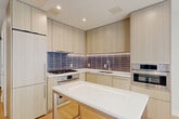 Located at 1224 M St NW in Washington, DC, this thoughtfully designed one-bedroom, one-bathroom residence offers a clean, modern aesthetic throughout. Light-toned hardwood flooring flows seamlessly across the entire space, complementing the crisp white walls and recessed lighting that create a bright, airy ambiance.

The open-plan living and dining area connects naturally to a well-appointed kitchen, which features flat-front cabinetry in a warm wood finish, quartz countertops, stainless steel appliances including a gas range and wall oven, and a stylish tiled backsplash. A central island provides additional prep and dining space.

The bedroom is filled with natural light from a large window overlooking the urban streetscape, offering a serene retreat. Two closets provide ample storage, while a hallway with louvered closet doors leads efficiently through the unit. A private balcony extends the living space outdoors.

The bathroom combines functionality with refined design, featuring large-format marble-look tile flooring, a floating wood vanity with white countertop, and a backlit mirror that adds a modern, spa-like touch. An in-unit laundry area adds everyday convenience.

The overall design is minimalist and contemporary, ideal for those seeking a polished urban living experience in Washington, DC.