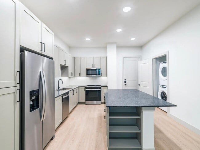 Take advantage of ample storage options including dedicated pantry and in island shelving. - Modera McKinney Ridge