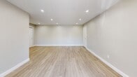 Located at 900 Mickley Rd in Whitehall, PA, this 1-bedroom, 1-bathroom unit offers a thoughtfully designed layout with modern finishes throughout. The spacious living room is highlighted by light wood-style flooring, recessed lighting, and a sliding glass door that opens to a private balcony overlooking a green outdoor landscape — filling the space with natural light and a refreshing sense of openness. Neutral gray walls and clean white trim create a bright, contemporary aesthetic throughout.

The kitchen is well-equipped with white shaker-style cabinetry, granite countertops, stainless steel appliances including a dishwasher and refrigerator, and a window with plantation shutters that lets in additional natural light. It flows conveniently into the main living area via a connecting hallway.

The generously sized bedroom features plush wall-to-wall carpeting, a ceiling fan with light fixture, a large double-door closet, and a window with views of the surrounding area. The full bathroom is tastefully finished with large-format tile surround, a soaking tub with rain showerhead, a marble-top vanity with white cabinetry, and a mirrored medicine cabinet — combining style and functionality in a compact, efficient space.