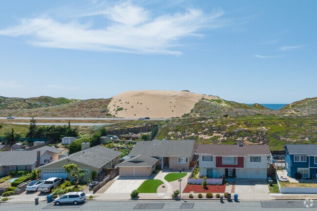 Massive dunes separate neighborhoods from the beach in Marina, California