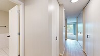 Located at 3200 Inglewood Ave S in St. Louis Park, MN, this one-bedroom, one-bathroom residence offers a thoughtfully arranged single-level floor plan that makes efficient use of its space. A welcoming entryway with built-in storage leads into the main living area, where light wood-style flooring transitions into plush carpeting. The open-concept kitchen features white cabinetry, stainless steel appliances including an electric range, a tile backsplash, and a pass-through counter that connects seamlessly to the living room — ideal for both everyday living and entertaining. The living room is bright and airy, with sliding glass doors opening onto a private balcony that offers pleasant views of the surrounding greenery. The bedroom is a comfortable, carpeted retreat with a large window that fills the room with natural light and provides additional outdoor views. Baseboard heating is present throughout. The bathroom is clean and functional, featuring white tile flooring, tile wainscoting, a vanity with ample storage, and matte black hardware accents. Neutral wall tones and consistent finishes throughout the home create a cohesive and inviting atmosphere.