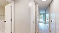 Located at 3200 Inglewood Ave S in St. Louis Park, MN, this one-bedroom, one-bathroom residence offers a thoughtfully arranged single-level floor plan that makes efficient use of its space. A welcoming entryway with built-in storage leads into the main living area, where light wood-style flooring transitions into plush carpeting. The open-concept kitchen features white cabinetry, stainless steel appliances including an electric range, a tile backsplash, and a pass-through counter that connects seamlessly to the living room — ideal for both everyday living and entertaining. The living room is bright and airy, with sliding glass doors opening onto a private balcony that offers pleasant views of the surrounding greenery. The bedroom is a comfortable, carpeted retreat with a large window that fills the room with natural light and provides additional outdoor views. Baseboard heating is present throughout. The bathroom is clean and functional, featuring white tile flooring, tile wainscoting, a vanity with ample storage, and matte black hardware accents. Neutral wall tones and consistent finishes throughout the home create a cohesive and inviting atmosphere.