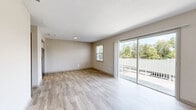 Located at 6900 Concord Drive in Tampa, FL, this one-bedroom, one-bathroom residence offers a thoughtfully organized single-floor layout with a clean, modern aesthetic throughout. The living room is bright and open, featuring light wood-style luxury vinyl flooring, neutral-toned walls, and large sliding glass doors that lead directly to a private balcony overlooking lush, mature greenery — filling the space with abundant natural light. The kitchen is efficiently designed in a galley configuration, showcasing granite countertops, white cabinetry with brushed nickel hardware, and stainless steel appliances including an electric range, dishwasher, microwave, and refrigerator. The bedroom offers a comfortable, carpeted retreat with a window that brings in natural light, and benefits from generous storage with multiple closets — three in total throughout the residence. The bathroom is well-appointed with a full tub-shower combination, wood-style tile flooring, a white vanity topped with granite countertops, and brushed nickel fixtures. The textured ceilings and consistent neutral color palette throughout tie the space together, creating a cohesive and move-in-ready atmosphere well-suited for comfortable everyday living.