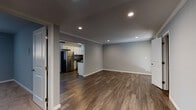 Located at 170 Locksunart Way in Sunnyvale, CA, this single-story unit presents a clean, modern aesthetic throughout its well-designed layout. Rich, dark wood-look flooring runs through the main living areas, complemented by soft gray walls and crisp white crown molding that add a polished finish to the open living space. Recessed lighting provides consistent illumination, enhancing the bright and welcoming atmosphere.

The kitchen is thoughtfully appointed with white shaker-style cabinetry, dark countertops, and a full suite of stainless steel appliances, including a refrigerator, electric range, microwave, and dishwasher. A window above the sink brings in natural light, adding an airy quality to the space.

The bedroom features neutral carpet flooring, a ceiling fan with light fixture, and a window with vertical blinds that allows for natural light. A built-in closet with shelving provides organized storage.

The bathroom is finished with a white vanity, dark countertop, a large mirror with modern lighting, and matching white cabinetry for additional storage. Wood-look flooring continues here, tying the unit together cohesively.

A sliding door off one area leads to a private outdoor patio, offering a functional extension of the living space.