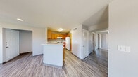 This single-floor residence offers a practical and comfortable layout designed for everyday living. The open living area greets you upon entry, featuring durable wood-look vinyl plank flooring, neutral gray walls, and a ceiling fan with overhead lighting. Recessed lighting and a glass-panel front door allow natural light to fill the space, creating a bright and welcoming atmosphere.

The kitchen is well-equipped with warm honey-toned wood cabinetry, white countertops, and white appliances including a gas range, dishwasher, and refrigerator. A peninsula counter provides additional workspace and connects the kitchen seamlessly to the living area, enhancing the open-concept feel.

The bedrooms are generously sized, each outfitted with ceiling fans and ample closet space. The primary bedroom features plush carpet, a large window overlooking the outdoors, and a walk-in closet. Additional bedrooms offer vinyl plank flooring, natural light, and convenient closet access.

Two bathrooms serve the home. The primary bathroom includes a vanity with dual mirrors, a tub-shower combination, and wood-look flooring. The secondary bathroom features a clean tub-shower surround with a built-in niche. Throughout the home, a consistent neutral palette and functional finishes create a cohesive, move-in-ready environment.