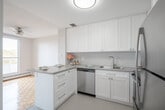 Located at 33 Leaside Dr in St. Catharines, Ontario, this 2-bedroom, 1-bathroom unit offers a well-organized and functional layout across a single floor. A bright, clean hallway with sliding storage doors and tile flooring serves as the entry point, leading into the main living areas. The combined living and dining room is generously proportioned, featuring classic parquet hardwood flooring and a ceiling fan, with large windows that invite abundant natural light and views of surrounding greenery. An adjacent dedicated dining area provides additional flexibility for everyday living. The kitchen is thoughtfully appointed with white shaker-style cabinetry, grey countertops, a subway tile backsplash, a stainless steel sink, and a stainless steel dishwasher, offering ample storage and counter space throughout. The primary bedroom is a comfortable, sun-filled room with parquet flooring and a window overlooking mature trees, while the second bedroom offers similar brightness and warmth. The full bathroom features a tiled tub-shower combination. A private balcony extends the living space outdoors. The unit's clean, neutral palette and consistent finishes contribute to a bright and welcoming overall ambiance.