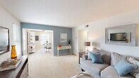 Located at 1905 Richardson Place Dr in Arnold, Missouri, this single-floor, 2-bedroom, 1-bathroom home offers a thoughtfully arranged layout across a comfortable footprint. The living room features soft neutral tones complemented by a striking blue accent wall, light carpet flooring, and ample room for relaxing or entertaining. Adjacent to it, the dining area is brightened by a window with natural light and equipped with a ceiling fan overhead, along with durable light wood-look flooring that extends through the kitchen. The kitchen provides generous cabinet storage with warm wood cabinetry, dark laminate countertops, a double-basin sink, and a pass-through window opening to the dining area. The primary bedroom is a well-proportioned retreat with carpeted flooring, a large window with outdoor views, and a standard closet. The second bedroom also features carpet, a blue accent wall, a closet with sliding doors, and natural light from a sizable window. The full bathroom is finished with wood-toned cabinetry, a large vanity mirror with lighted fixture, and a tub-shower combination. Throughout the home, a cohesive color palette of soft blues, beiges, and whites creates a calm, welcoming ambiance.