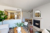 Located at 16802 E Wyoming Cir in Aurora, CO, this thoughtfully designed one-bedroom, two-bathroom single-floor residence offers a comfortable and functional layout. The open-concept living and dining area serves as the heart of the home, featuring wood-look flooring, a textured ceiling, a ceiling fan, and a classic fireplace that adds warmth and character. A sliding glass door floods the living space with natural light and opens to a private patio with pleasant outdoor views.

The kitchen is efficiently designed with gray shaker cabinetry, white quartz countertops, a white subway tile backsplash, and a full suite of stainless steel appliances including a refrigerator, range, dishwasher, and range hood. A pass-through counter connects the kitchen seamlessly to the living and dining areas.

The spacious bedroom features plush carpeting, ample natural light, and generous closet space. Both bathrooms are clean and well-appointed — one includes a wide vanity with gray cabinetry and gold-toned hardware, while the second offers a full tub-shower combination. Additional highlights include an in-unit laundry area and a dedicated utility room, rounding out this efficient and inviting Aurora home.