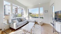 Located at Reunion Avenue in Victoria, BC, this well-designed 2-bedroom, 2-bathroom unit offers a thoughtfully organized single-level layout with a clean, modern aesthetic throughout. Light wood-tone flooring flows seamlessly across the open-plan living, dining, and kitchen areas, creating a cohesive and airy feel.

The kitchen is a functional centrepiece, featuring warm wood cabinetry, white countertops, stainless steel appliances, and a spacious island with bar seating — ideal for casual dining or entertaining. A hallway connects the kitchen to both bathrooms, one of which features a wood-toned vanity with an undermount sink, large mirror, and a glass-enclosed walk-in shower with tile surround.

The living room is bright and welcoming, anchored by oversized windows that fill the space with natural light and provide views of the surrounding neighbourhood. Both bedrooms continue the light wood flooring and feature windows that bring in daylight. The primary bedroom includes a built-in closet, while the second bedroom offers a quieter, more private setting.

Clean white walls and a neutral palette throughout lend the unit a calm, contemporary ambiance, making it a comfortable and practical home in a well-connected Victoria location.