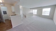 This 670 square foot apartment in Van Buren Township, Michigan, offers a well-designed living space on a single floor. The property features one bedroom, measuring 180 square feet, and one bathroom. The open-concept design combines the kitchen and living room, creating a spacious feel in the compact layout.

The kitchen is modern and functional, equipped with white cabinetry, dark appliances, and a stylish countertop. It includes a gas range, refrigerator, and ample storage space. The living area is bright and airy, with large windows that allow natural light to flood the space. Soft, neutral-toned carpeting covers the floors in the main living areas and bedroom, while the kitchen features durable wood flooring.

The bathroom is efficiently designed with a combined tub and shower unit, perfect for both relaxation and practicality. The property also includes an in-unit laundry area, adding convenience to daily living.

Throughout the apartment, the walls are painted in light, neutral tones, creating a clean and versatile canvas for personal decorating styles. The overall design emphasizes functionality and comfort, making excellent use of the available space. This apartment is well-suited for singles or couples looking for an efficient and modern living environment in a convenient Michigan location.