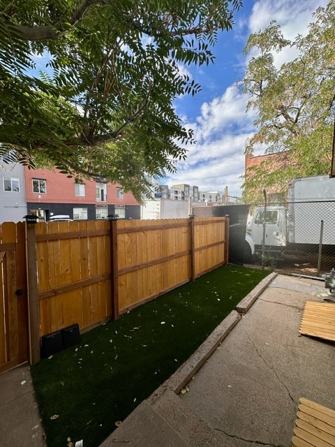 Small astroturf patio behind mural; front entrance from Walnut St. - 2748 Walnut St Apartments