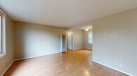 Located at 95 Kirkham St in San Francisco's Inner Sunset neighborhood, this single-floor unit offers a well-organized layout with consistent design elements throughout. Warm-toned hardwood flooring runs continuously across the living areas and bedrooms, creating a cohesive and inviting atmosphere.

The main living area is open and generously proportioned, featuring neutral beige walls and smooth ceilings with a ceiling fan. It flows naturally into an adjacent room, providing flexibility for dining or additional living space. Large windows with vertical blinds allow abundant natural light and offer pleasant views of the surrounding greenery.

The bedrooms are comfortably sized, each featuring the same hardwood flooring. One bedroom includes a sliding-door closet with built-in shelving, offering practical storage. Windows in the bedrooms frame views of mature trees, reinforcing a calm, natural ambiance.

The kitchen is efficiently designed with white shaker-style cabinetry, speckled stone countertops, a stainless steel electric range, over-the-range microwave, and a white sink positioned beneath a window. The bathroom features a white vanity with chrome fixtures, a combined tub and shower with white tile surround, and a wall-mounted mirror.

Overall, the space presents a clean, move-in-ready environment with consistent finishes throughout.