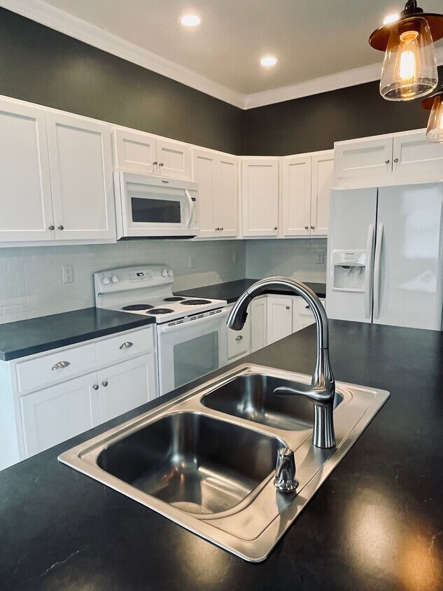 Kitchen includes counter-heigh island bar that accommodates seating - 1718 Grace Ave