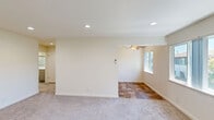 Located at 535 E Maude Ave in Sunnyvale, California, this well-appointed one-bedroom, one-bathroom unit offers a thoughtfully organized single-floor layout. The living area is finished with neutral-toned carpet, recessed lighting, and a wall-mounted mini-split HVAC system for year-round comfort. A window brings in natural light and frames views of surrounding greenery, creating a calm and airy atmosphere.

The galley-style kitchen is a functional highlight, featuring warm honey-toned wood cabinetry on both sides, light granite-look countertops, white appliances including a gas range, microwave, refrigerator, and dishwasher, as well as a single-basin sink. Stone-patterned tile flooring runs through the kitchen and extends into the adjacent dining area, which is brightened by two windows overlooking lush outdoor foliage and topped with a ceiling fan.

The bedroom is generously proportioned, with plush carpet, recessed lighting, and a wide window that fills the room with natural light and leafy views. It connects directly to the bathroom, which is clean and modern, featuring a combined tub and shower with sliding glass doors, a white vanity with an undermount sink, a large mirror, and wood-look tile flooring. This unit blends practicality with comfort in a convenient Sunnyvale location.