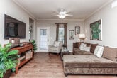 Located at 1650 S Fox Run Pkwy in Opelika, Alabama, this single-floor residence offers a thoughtfully designed layout that balances comfort and functionality. The living area serves as the heart of the home, featuring warm hardwood-style flooring, crown molding, and natural light streaming through multiple windows with sheer drapes. A ceiling fan adds a practical touch to this welcoming space.

The kitchen is well-equipped with light maple cabinetry, granite-style countertops, stainless steel appliances including a range, microwave, and refrigerator, and a double-basin sink set into a curved peninsula—ideal for both cooking and casual dining.

Two carpeted bedrooms provide comfortable retreats, each with ample natural light courtesy of window treatments. The primary bedroom offers a serene, neutral palette, while the secondary bedroom features a classic iron bed frame and coordinating dresser.

Two full bathrooms mirror each other in design, each outfitted with warm wood-toned vanity cabinetry, granite-style countertops, and hardwood-style tile flooring. One bathroom includes a shower-tub combination. A compact, built-in home office nook with a granite-topped desk and natural light from a side window rounds out this efficiently designed single-level home.