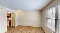 Located at 2800 Alumni Dr in Lexington, KY, this two-story, 2-bedroom, 1-bathroom home is thoughtfully laid out across two evenly sized floors. The main level features a bright living room with wood-look flooring, neutral cream-toned walls, and a large window that invites natural light. Adjacent to the living room, the kitchen is well-equipped with warm oak cabinetry, dark laminate countertops, a double-basin sink, and white appliances including a coil-top range and refrigerator, plus a window above the sink for added light. The upper level houses both bedrooms, each featuring the same warm wood-look flooring, textured ceilings, and windows fitted with blinds for natural light and privacy. The primary bedroom offers a closet, while both rooms maintain a clean, neutral aesthetic throughout. The full bathroom includes a tub-shower combination with a curtain rod and tiled flooring. A notable feature of this home is its abundance of closet space, with six closets distributed across the layout. Hallways, staircases, and a utility room complete the functional floor plan, providing practical storage and circulation throughout the home.