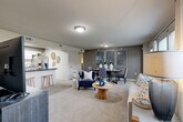 This single-story residence in Temple, TX offers a thoughtfully designed open-concept layout across three bedrooms and two bathrooms. The living and dining area flows seamlessly together, featuring plush neutral carpeting, soft neutral-toned walls, and large windows that invite an abundance of natural light. A sliding glass door in the living room provides outdoor access and enhances the bright, airy atmosphere.

The kitchen is well-equipped with white shaker-style cabinetry, dark granite countertops, a classic subway tile backsplash, wood-look tile flooring, and stainless steel appliances including a refrigerator with ice maker, range, and microwave. A breakfast bar with counter seating connects the kitchen to the living space.

The primary bedroom is generously sized with carpeted floors, a ceiling fan, and a window with outdoor views. It features a dedicated walk-in closet with wire shelving for organized storage. The additional bedrooms are equally comfortable, each with ceiling fans and natural light. A second closet provides further storage convenience.

Both bathrooms are tastefully finished, with the full bath showcasing white cabinetry, dark granite countertops, and wood-look flooring. The overall ambiance throughout the residence is warm, neutral, and functional, making it a comfortable and practical home.