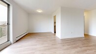 Located in Mornington, London, Ontario, this well-appointed one-bedroom, one-bathroom unit offers a thoughtfully designed single-floor layout. Light-toned hardwood flooring runs throughout, lending a clean and cohesive look to every room. The open living room is a standout feature, bathed in natural light thanks to a large sliding glass door that leads to a private balcony with views of surrounding greenery — an ideal spot for relaxing or enjoying fresh air. A baseboard heating system ensures year-round comfort. The kitchen is efficiently laid out with white cabinetry, dark countertops, a double stainless steel sink, and a classic subway tile backsplash, complemented by stainless steel appliances including a refrigerator and dishwasher. The bedroom offers a comfortable, well-sized retreat with a large sliding closet and a window overlooking the outdoors, providing both natural light and ventilation. The bathroom is finished in a crisp, modern style with white cabinetry, a stone-patterned countertop, an integrated sink, and tile flooring. The overall aesthetic is bright, clean, and contemporary, making this a practical and inviting space in a residential London neighbourhood.