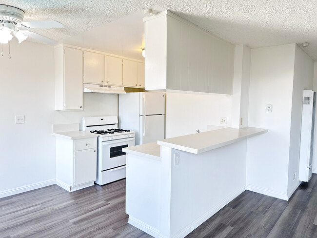 kitchen furnished with stove, over, and fridge - Vanderbilt West