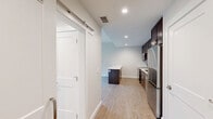 Located at 111 Lamme St in the heart of Bozeman, Montana, this thoughtfully designed one-bedroom, one-bathroom unit offers a efficient and modern living experience. Light-toned luxury vinyl plank flooring flows throughout the space, complementing the clean, white walls and recessed lighting that keep the interior bright and inviting.

The kitchen is a standout feature, showcasing rich dark-espresso cabinetry, white quartz countertops, a classic white subway tile backsplash, and a full suite of stainless steel appliances including a range, microwave, dishwasher, and refrigerator. A kitchen island with a matching dark base and white countertop provides additional prep and dining space, while an adjacent barn-style sliding door adds a modern architectural touch.

The bedroom is a comfortable, well-proportioned retreat with a large window that allows natural light to filter in. The clean, neutral palette creates a calm and restful atmosphere.

The bathroom features a frameless sliding-glass walk-in shower with white tile surround, a dark-wood vanity with a white countertop and undermount sink, and a large mirror — all finished with consistent, contemporary styling.

The overall design of this unit is clean, modern, and efficiently organized, making it an ideal residence in one of Montana's most vibrant cities.